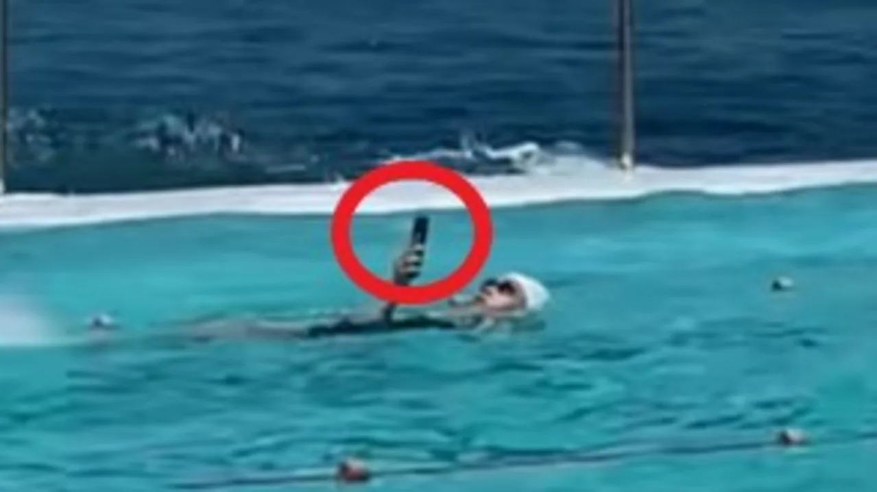Swimmer uses phone while doing laps at Bondi Icebergs pool, sparking online debate